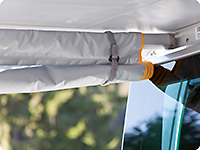 The side panel can also be rolled up and fixed to the awning arm.