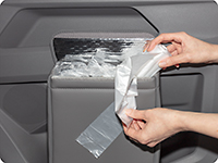 A waste bag supply roll is placed in the MULTIBOX and the first bag is pulled up.